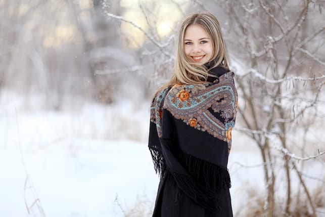 a young blonde woman posing outdoors in winter