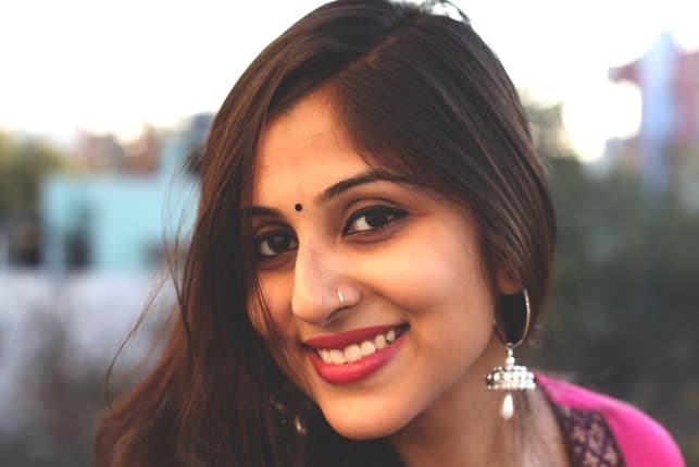 a young indian woman posing outdoors