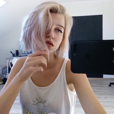 a young blonde girl taking a selfie