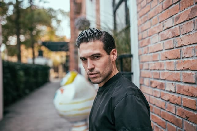 an attractive dark man looks with suspicion