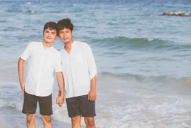 an Asian gay couple on the beach