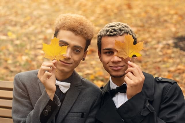 a gay couple posing with leaves together