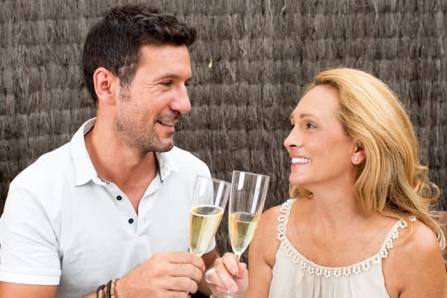 a mature couple drinking champagne together