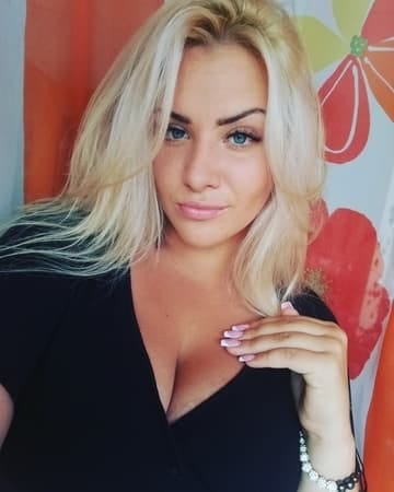 a blonde woman making a selfie at home