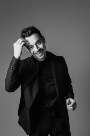 a black-and-white portrait of a young attractive man in a suit