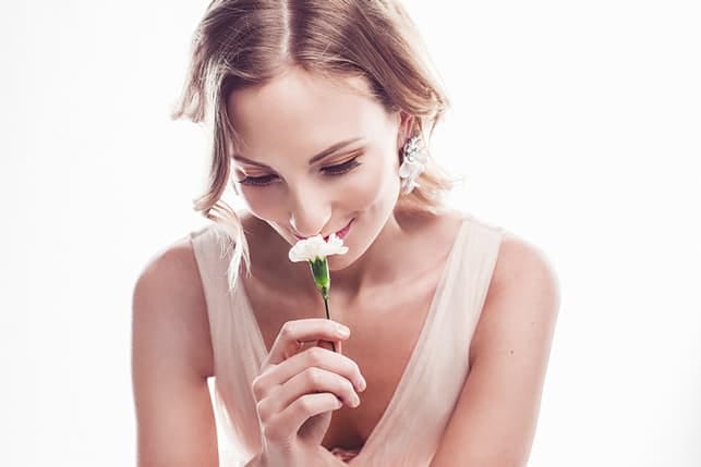 a woman smelling a flower