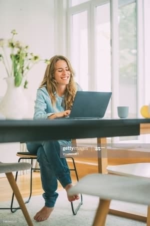 a blonde woman using her laptop