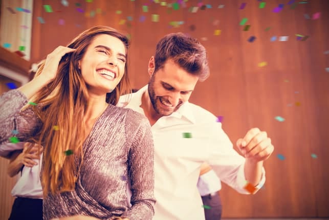 a happy couple dancing at a party