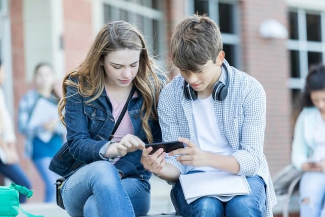 a young couple using a smartphone together