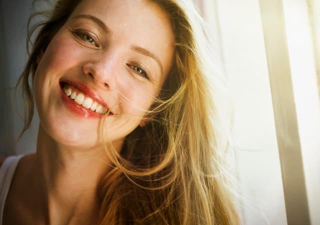 a portrait of a blonde girl smiling