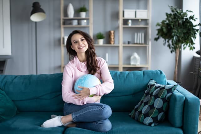 a woman holding a globus while being at home