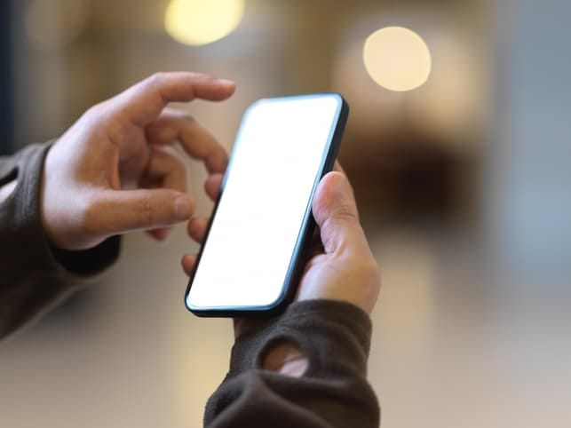 hands of a man using his smartphone