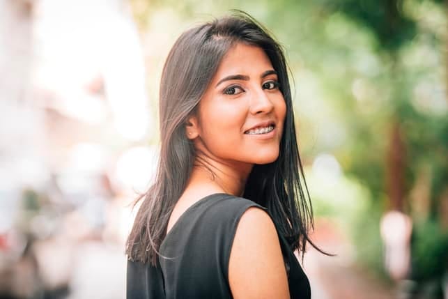 a portrait of a young asian woman outdoors
