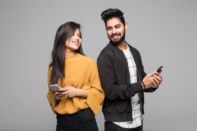 a modern Indian couple using dating apps to meet each other