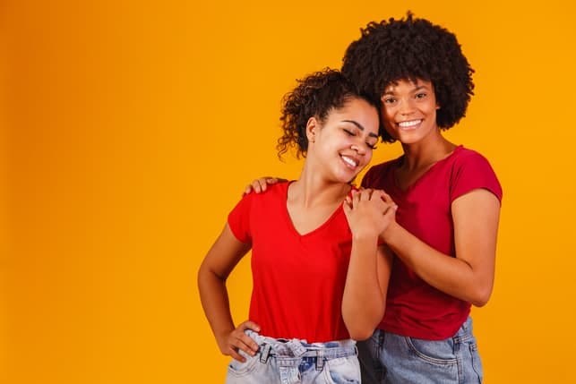 two black lesbian girls wearing red t-shirts