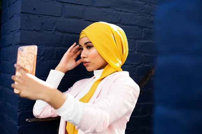 a beautiful muslim woman taking a selfie