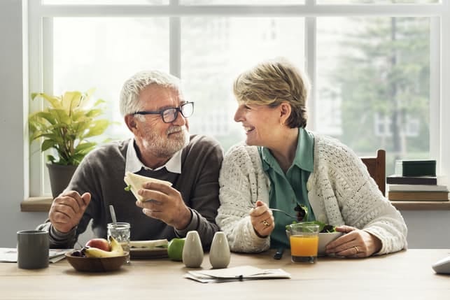 a mature couple having breakfast at home together