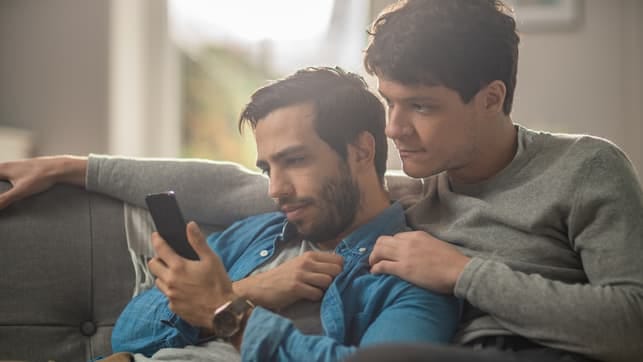 a gay couple using a smartphone together