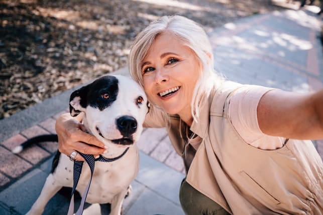a portrait of a happy mature woman with a dog