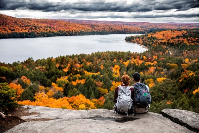 a couple enjoying a view while camping in the autumn