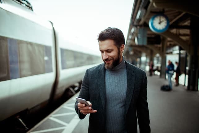 a man is checking his messages and smiling